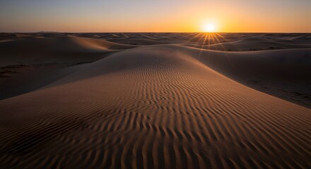 Desert dunes with rippled sand patterns at sunrise