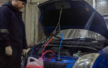 replacing antifreeze in a car, filling with coolant using a hose