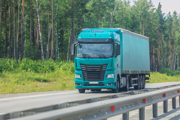 truck with a container moves along a country road