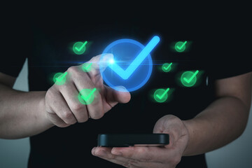 Quality Assurance. business man touching virtual correct sign with mobile smartphone, satisfaction, customer review, quality control, business finance, guarantee, cybersecurity technology concept