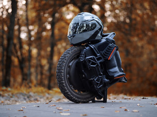 Electric Unicycle and Helmet in Autumn Park © pavelkant