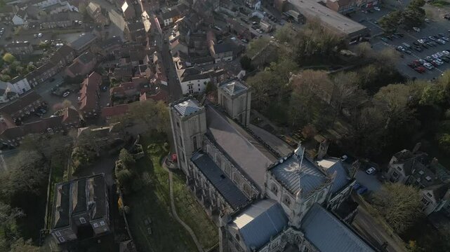 Breathtaking aerial view of Ripon Cathedral under the bright sun illuminating the historic architecture and tranquil surroundings