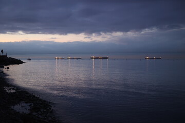 The water is calm and the sky is dark