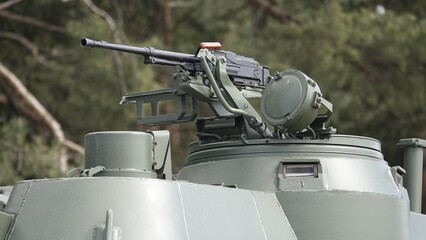 Combat turret on the roof of an armored army vehicle for transporting infantry with a roof-mounted...