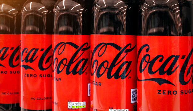 Coca Cola logo on bottle of Coke Zero drinks - close up of sugar free carbonated beverage produced by the Coca Cola Company.