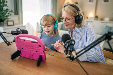 Grandchild and grandma record podcast and use tablet together