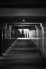 Underground Tunnel with Tiled Walls and Columns, Stairs in the Distance with Unidentifiable Figures