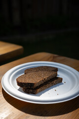 Slices of Dark Bread on a Plate Placed on a Table