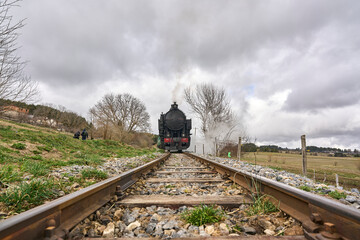 Vintage steam train in rural landscape