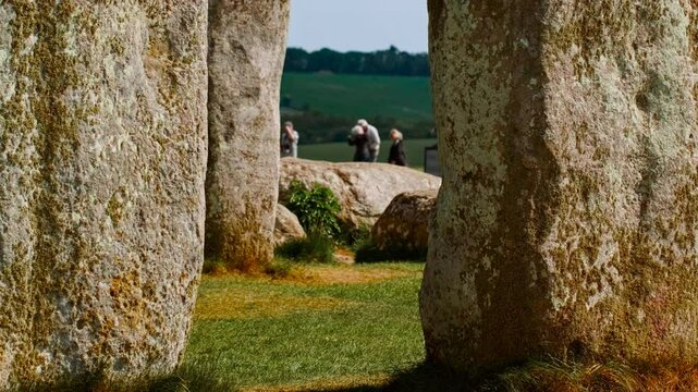 Stonehenge establishing shot revealing ground level perspective of interlocking stones forming sacred circle, Salisbury, Wiltshire, England, UK