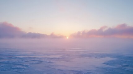 Fototapeta premium Pastel sunrise over a misty, tranquil landscape.