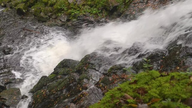 Drone captures Belye Mosty Waterfall surrounded by colorful autumn forest foliage and rugged terrain in Karelia, Russia&rsquo;s wilderness.