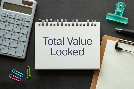 There is notebook with the word Total Value Locked. It is as an eye-catching image.
