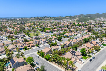 Aerial view of San Marcos neighborhood with houses and street during sunny day, South California,...
