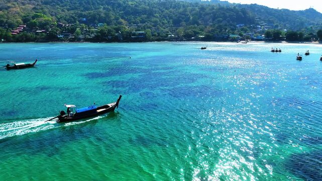 Aerial: Drone Panning Scenic Shot Of Motorboat Moving On Sea By Phi Phi Island During Sunny Day - Phi Phi Islands, Thailand