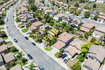Aerial view of San Marcos neighborhood with houses and street during sunny day, South California, USA.