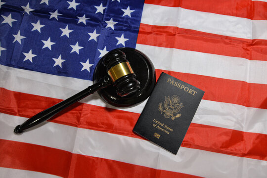 American passport with Court gavel and flag in the backdrop, United States residence and traveling concept background. Citizenship, immigration - Powered by Adobe