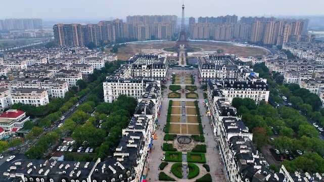 Aerial Forward Shot Of Fake Eiffel Tower In Residential City Against Clear Sky - Hangzhou, China