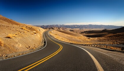 Fototapeta premium a wide angle perspective of a winding road with a yellow centerline cutting through dry barren hills representing an ongoing journey through a desolate yet picturesque landscape