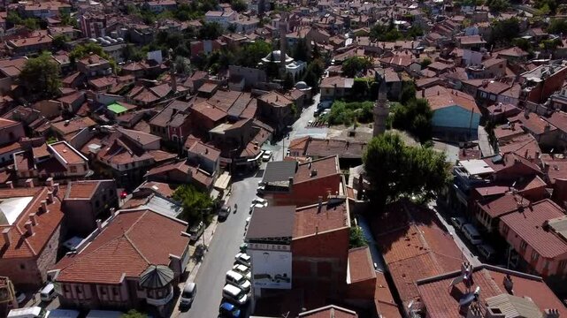 Aerial Shot Of Famous Mosques Amidst Roofed Houses On City Landscape, Drone Flying Forward During Sunny Day - Afyonkarahisar, T�rkiye