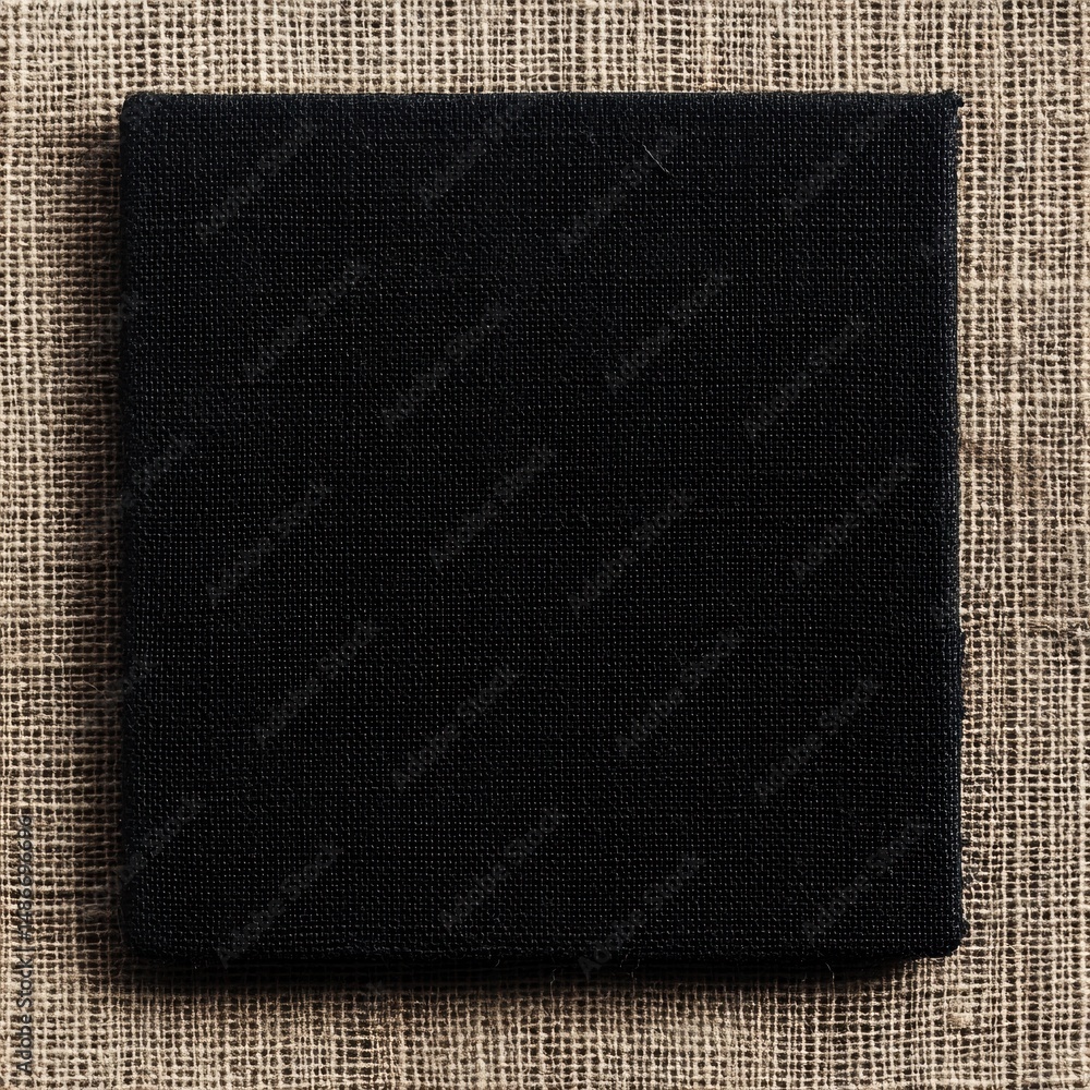 Poster minimalist black square isolated against a textured fabric background, showcasing suprematist art st