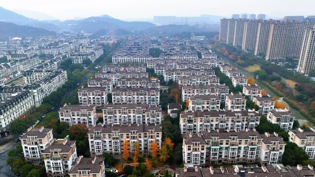 Aerial Forward Shot Of Residential Buildings In City By Mountains Against Clear Sky - Hangzhou, China