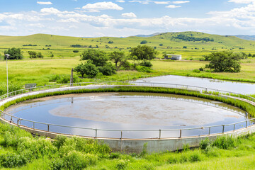 aerial perspective of circular wastewater clarifier tank with geometric sludge patterns