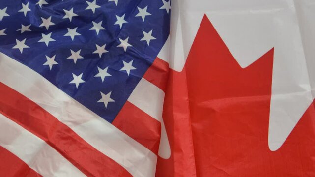 The United States of America and Canada flag representing diplomatic relations between two coutries, 4k footage.
