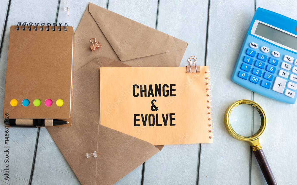 Poster the text change evolve written on a piece of paper of a notebook standing on the table.