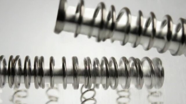 Tension Springs Falling on a Light Background. Metal Springs 3D Animation. 4K