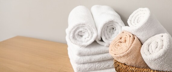 Clean soft towels on table in bathroom, closeup. Banner for design