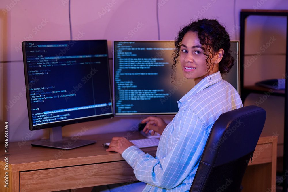Aufkleber young african-american qa engineer working with computer in office at night