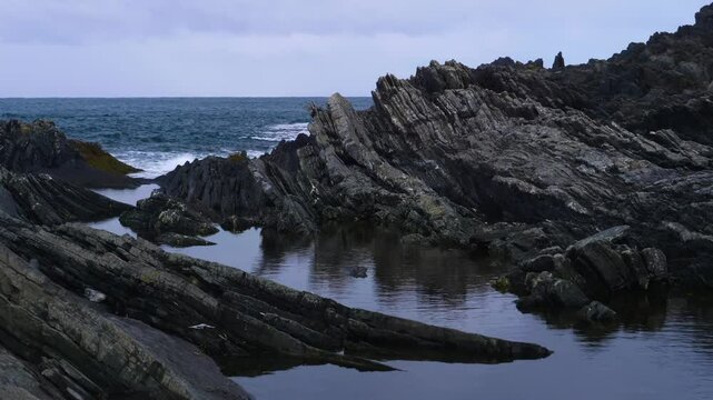 Drone footage of the Anita Garibaldi Promenade in Nervi, Genoa, Italy, reveals intricate tide pools and a scenic rocky shoreline