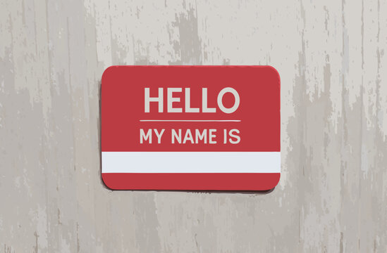 Red name tag on a textured background, inviting introductions.