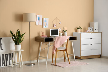 Interior of fashion designer's office with workplace and lamp
