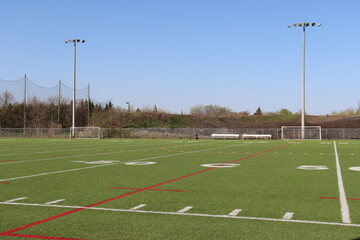 A view of a soccer field and sport activity. Sports field with a blue sky. Competition and...