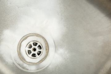 Sink with clogged drain and baking soda, closeup