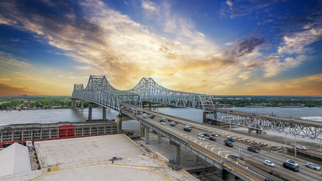 aerial shot of cars and truck driving on the Crescent City Connection bridge over the Mississippi River in New Orleans Louisiana USA