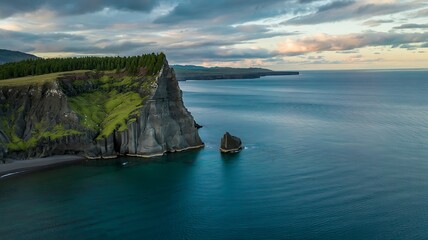 Fototapeta premium Dramatic Coastal Cliffs and Azure Waters of Iceland with Cloudy Sky Landscape