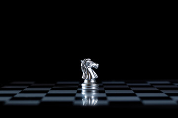 silver Knight stands out  board, rising dark black against the golden pieces successfully convey  unique Queens strategy, thinking out of the box that will become a strategic business thinking idea. © Viriyastock88