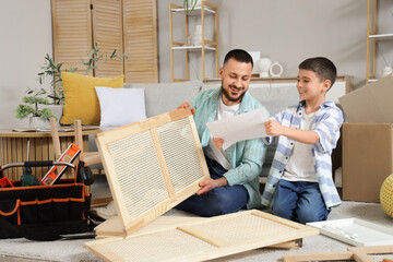 Father with his son assembling folding screen at home