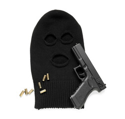 Balaclava with gun and bullets on white background