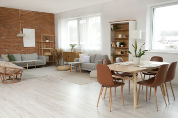 Interior of studio apartment with sofas, dining table and shelf units