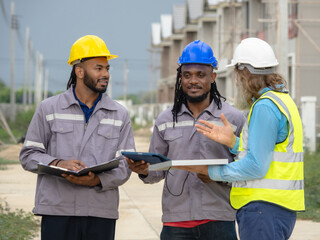 Fototapeta premium Professional architect and foreman wear head hat talk meeting safety work team check inspection tablet document ergy sorlar panels improvement project plan design home building in construction site.