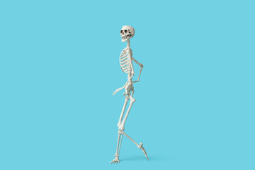 Scary human skeleton running on blue background
