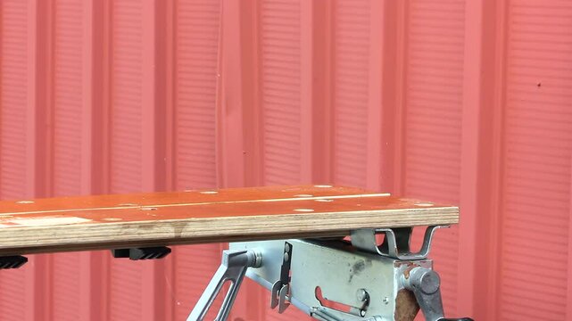 Pair Of Male Hands Take Vehicle Starter Off A Wood Bench And Puts Back