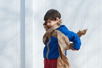 young boy playing with paper