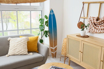 Interior of living room with surfboard and sofa
