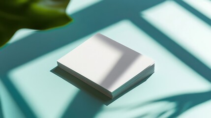 Blank white paper stack minimalist design sunlight shadows teal background