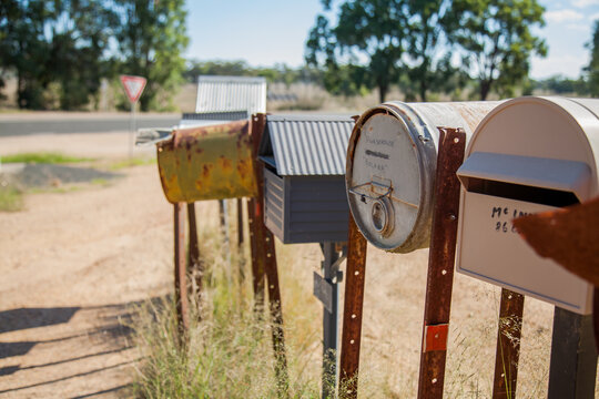 Row of country mailboxes on rural dirt road
